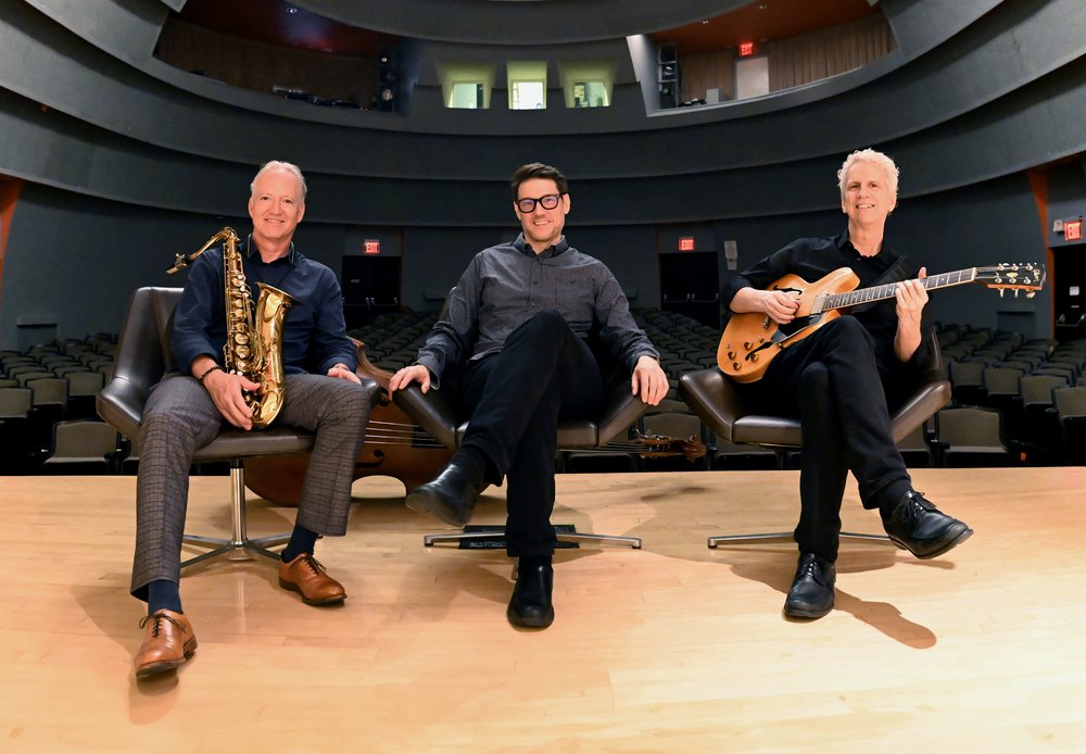 Ted Nash Trio in chairs on a stage in a listening hall