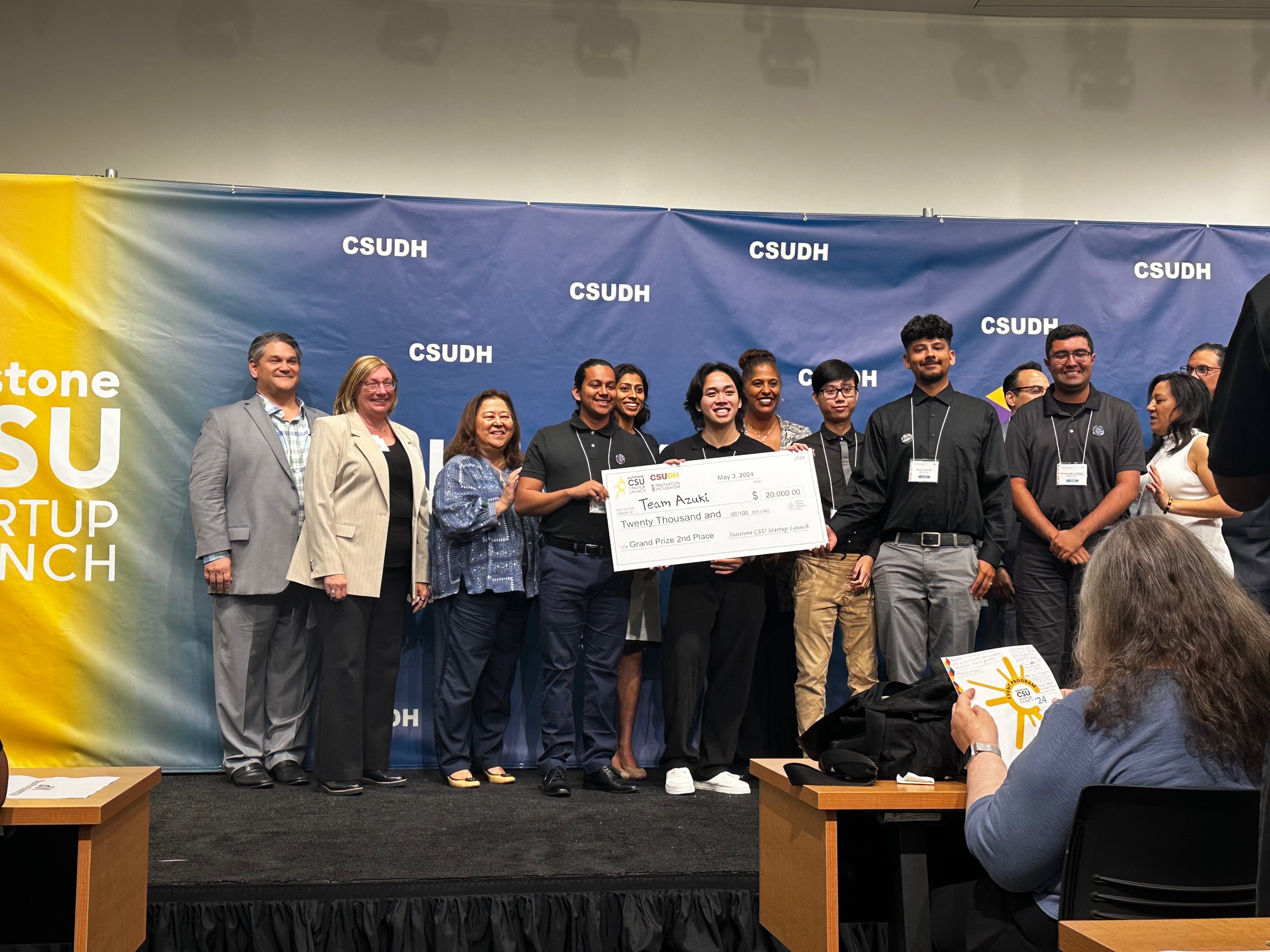 Sac State students hold a $20,000 check