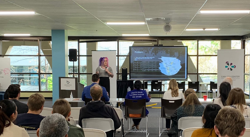 Female student pitching at the Carlsen Center