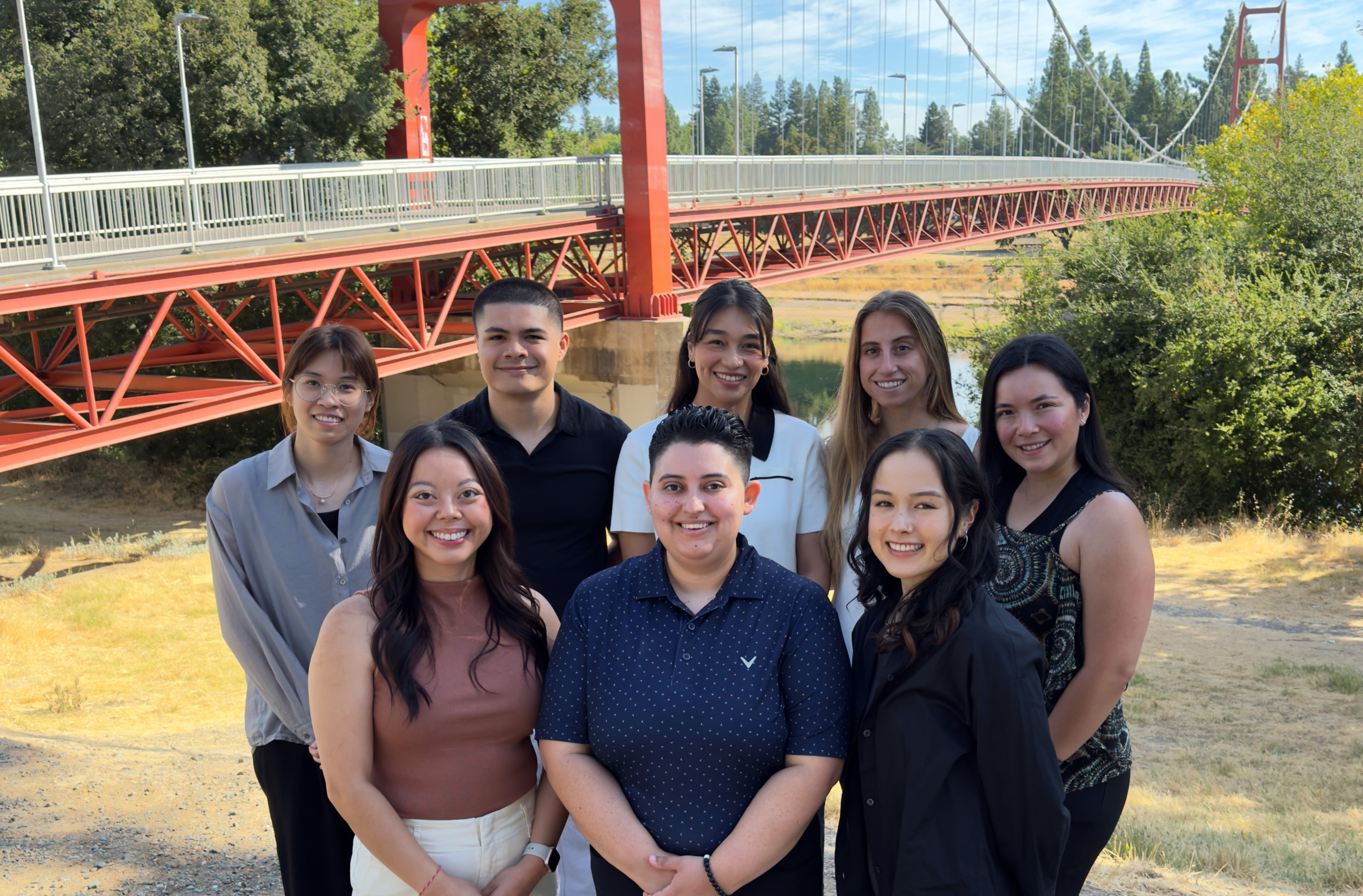 Dietetic internship cohort standing in front of Guy West Bridge. 