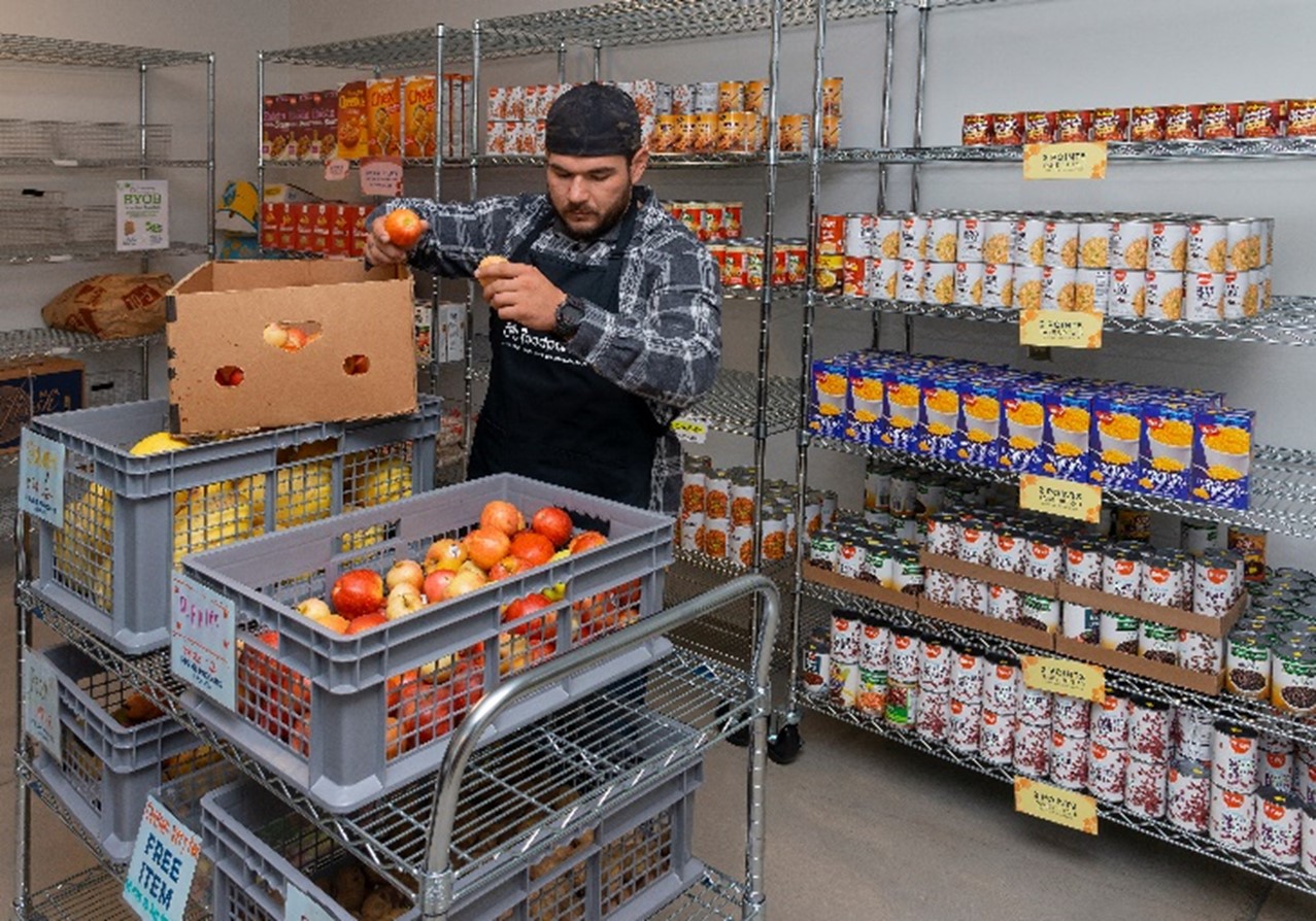 student at campus ASI food pantry looking at all the fresh food