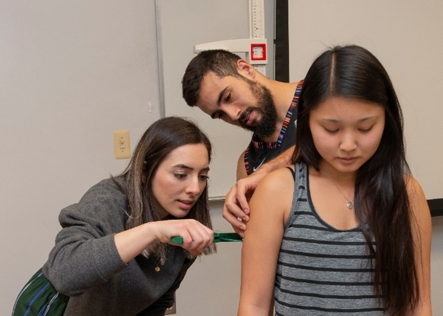 Students measuring body fat percentage in class