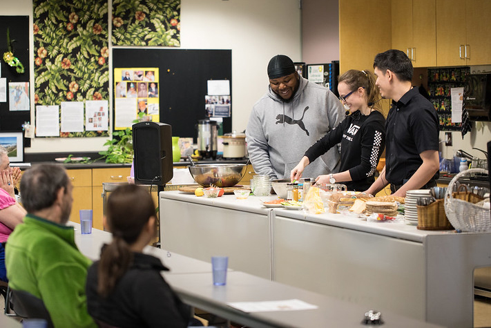 Students doing a cooking demonstration.