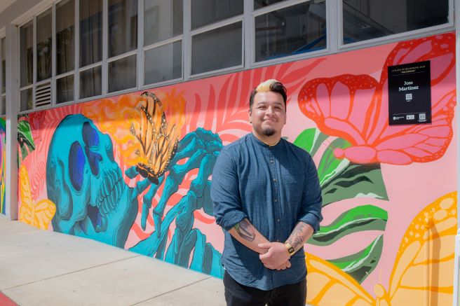 Jose Martinez in front of Becoming Mural