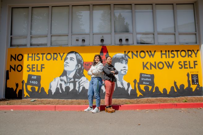 Julie Crumb and Alejandra Ruiz in front of Becoming Mural