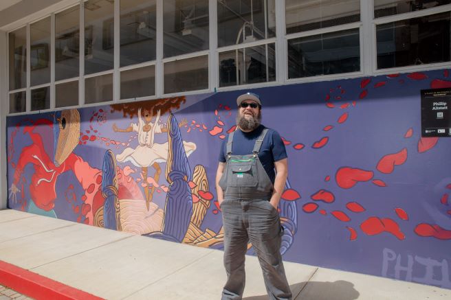Phillip Alstatt in front of Becoming Mural
