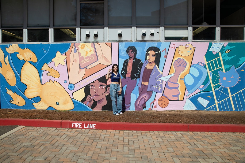Diana Valle in front of her mural