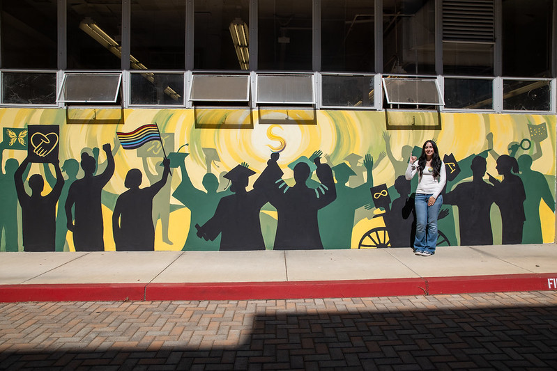 Sarah Guadagnolo in front of her mural
