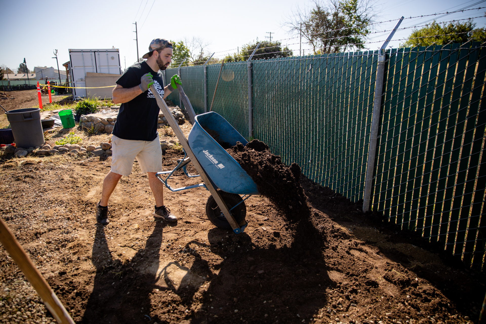 Employee shoveling compost