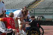 Therapeutic recreation student Cyndie Ward presents athlete with a medal at the track event