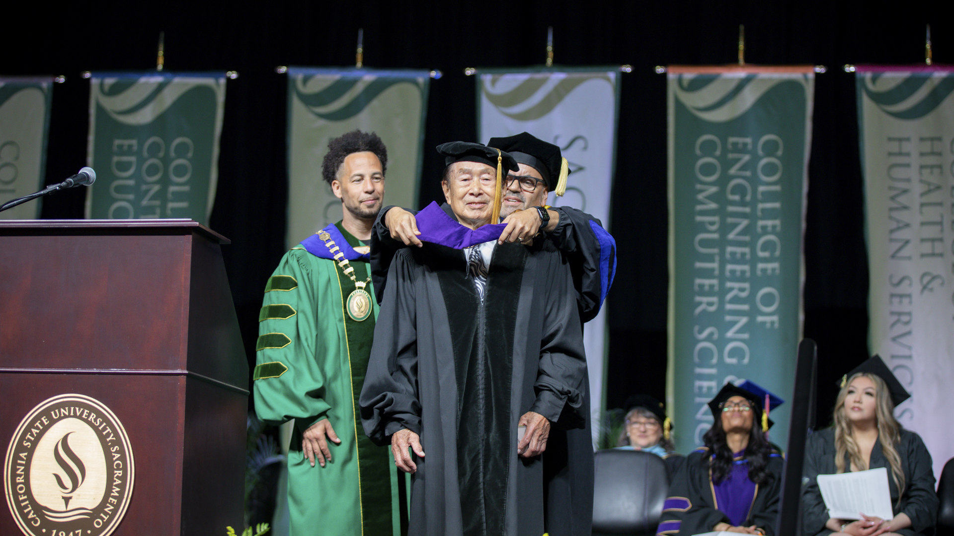 President Wood and Carlos Nevarez honor Roger Fong at Commencement.