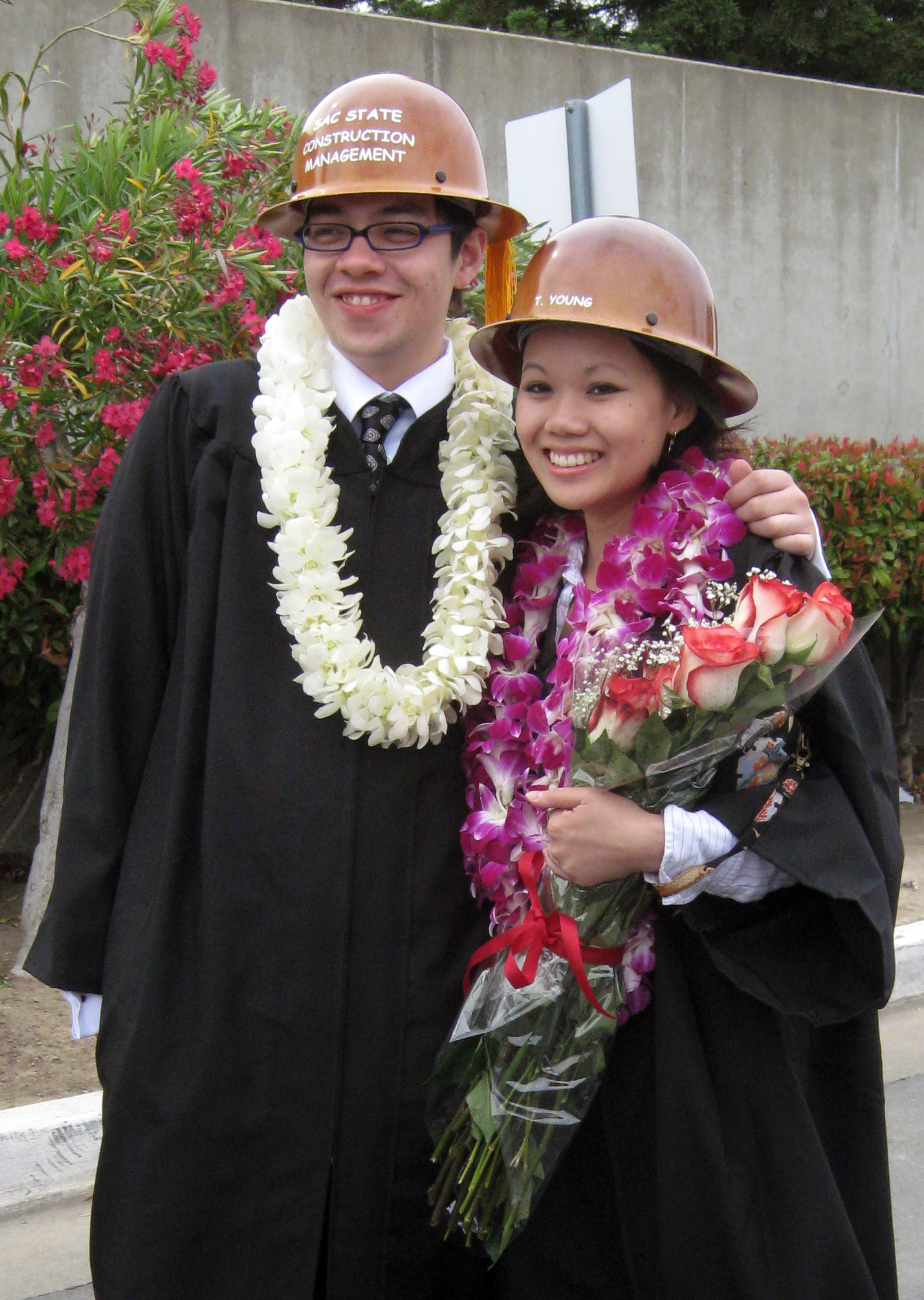 Ryan Sutton-Gee and Tracy Young wearing academic regalia at their graduation from Sac State.