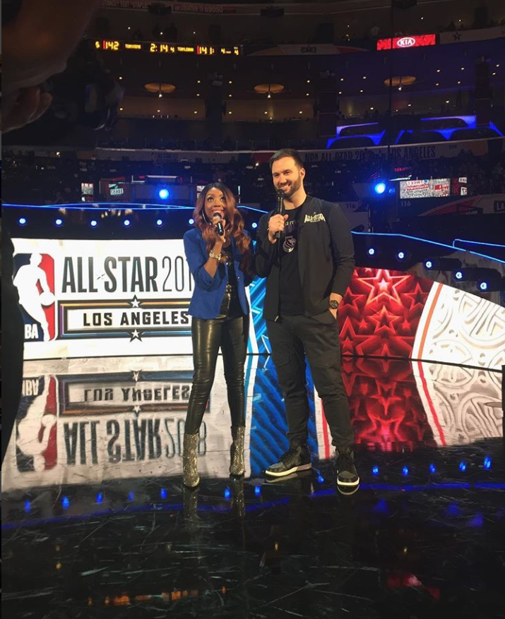 Scott Freshour on the arena floor holding a microphone during an NBA All-Star Game.