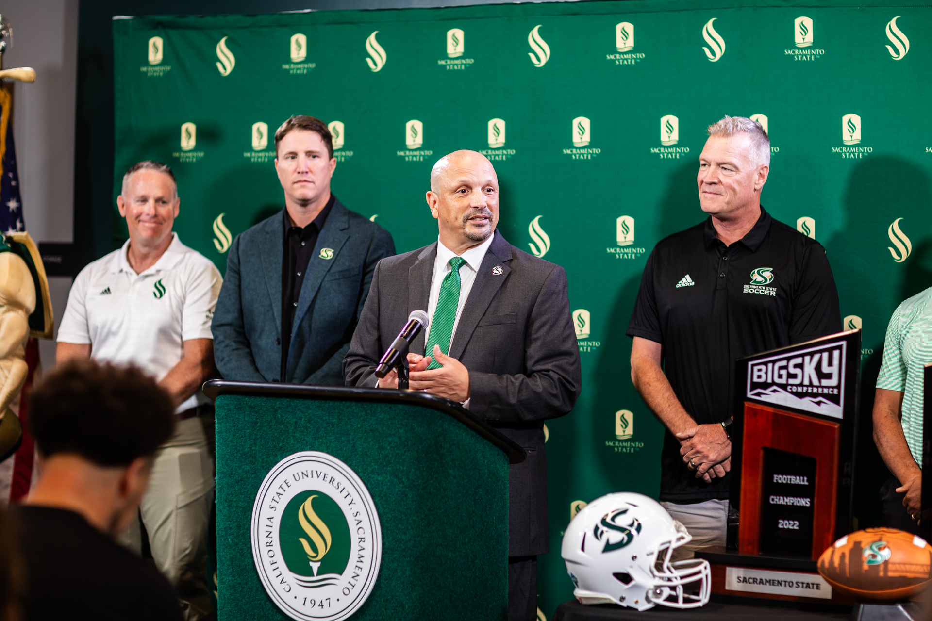 Mark Orr and others from Sac State Athletics at the podium in the Welcome Center.