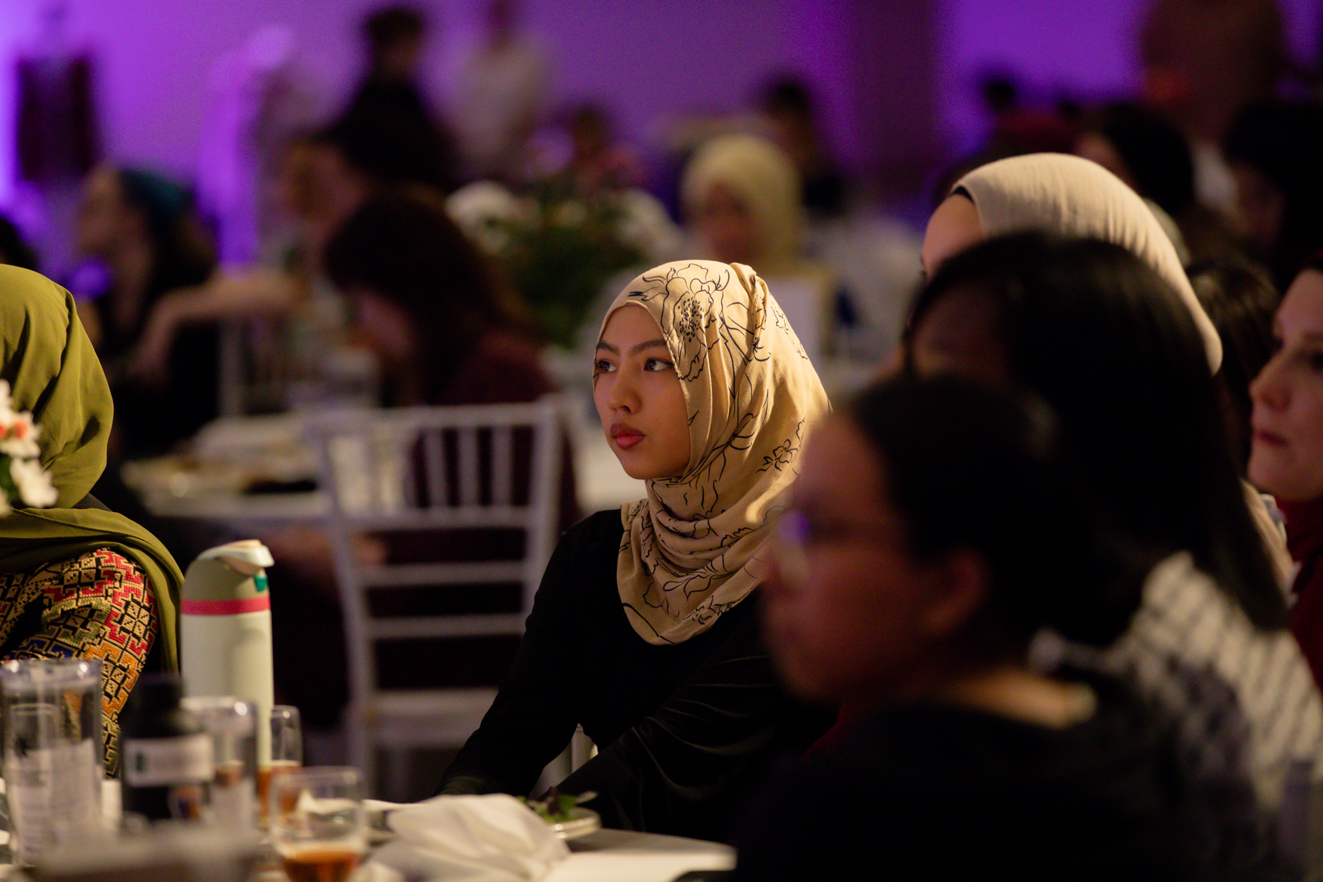 A woman sits in the audience during the grand opening of the SWANA Center.