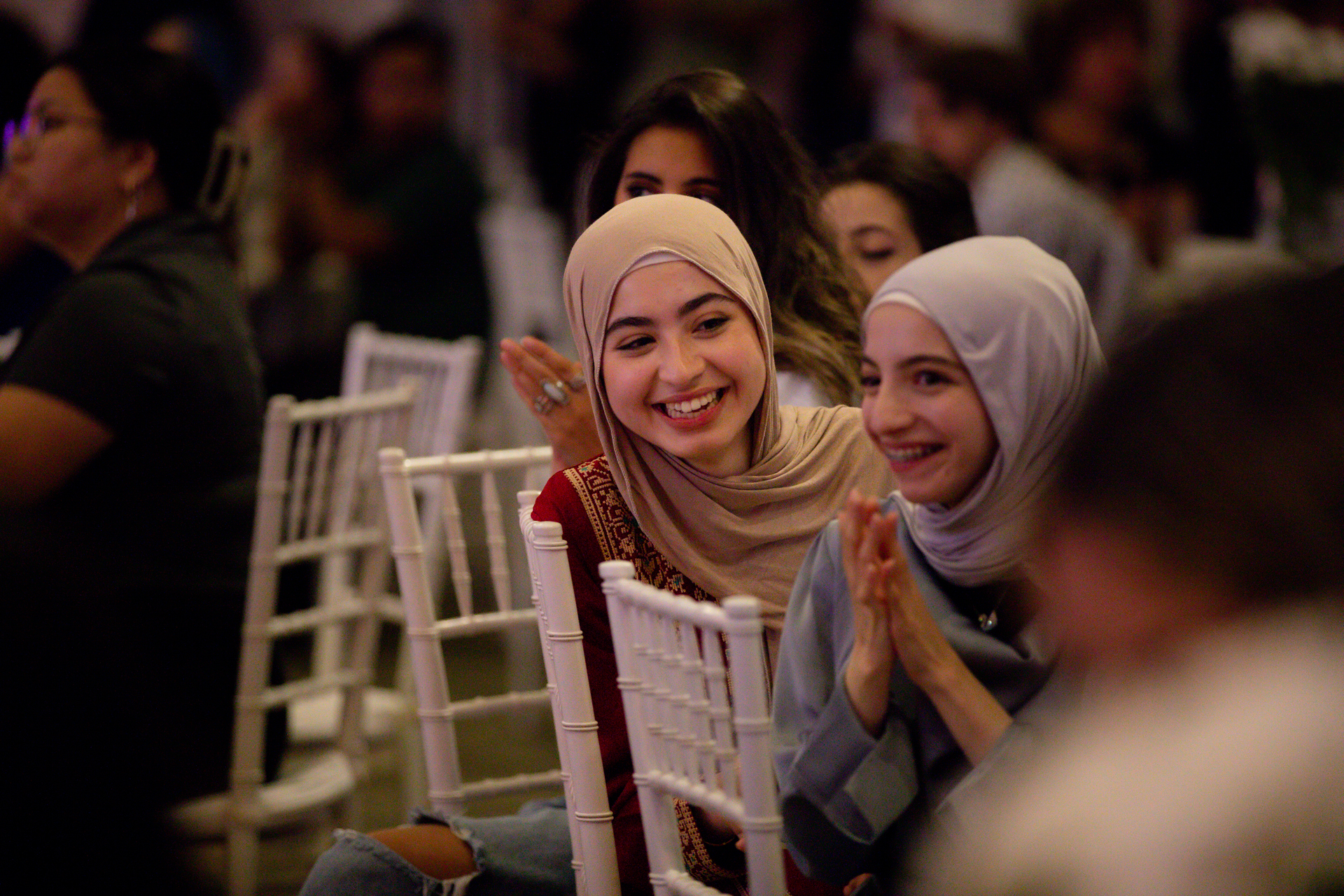 Two women, sitting and smiling during the grand opening celebration for the Sac State SWANA Center.