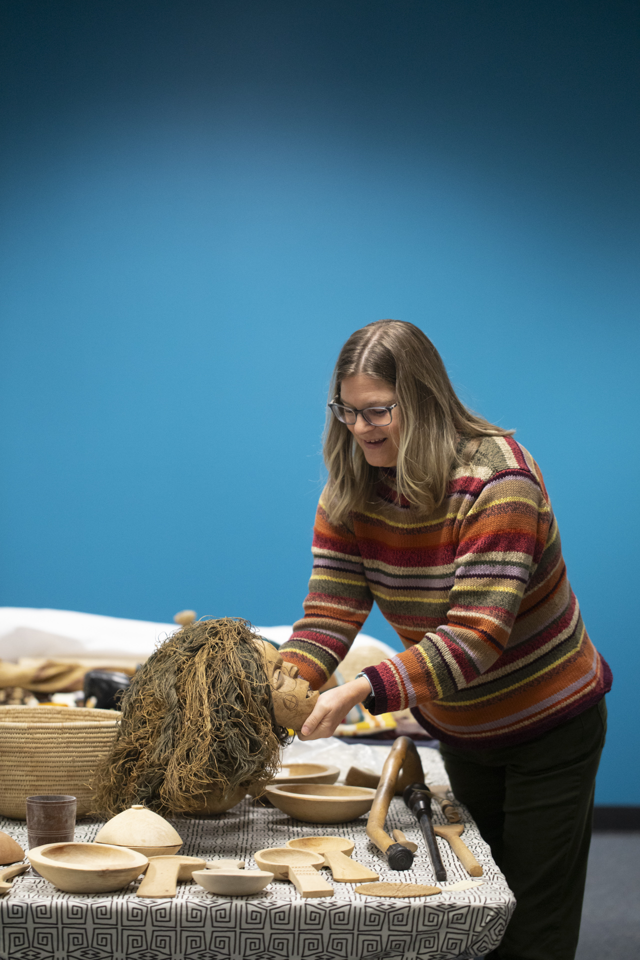 A Sac State professor handles an African artifact during a cataloging project.