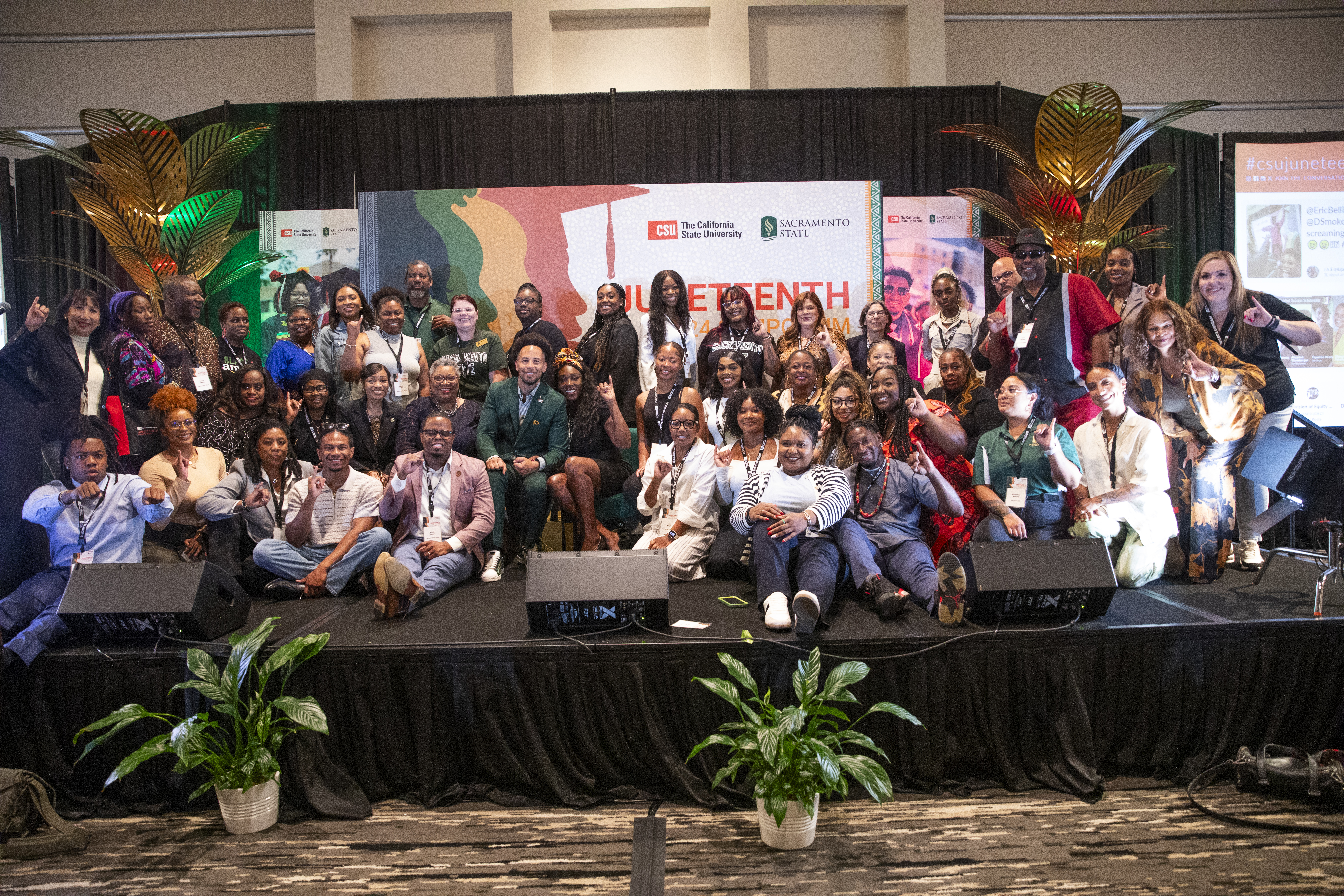 Sac State staff and students posing and hitting the "Stinger's Up"