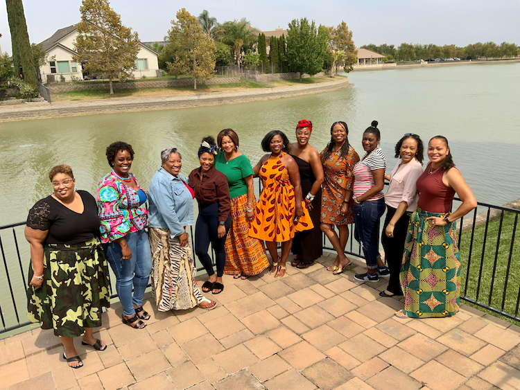 A group of Black/African American women pose for a photo.