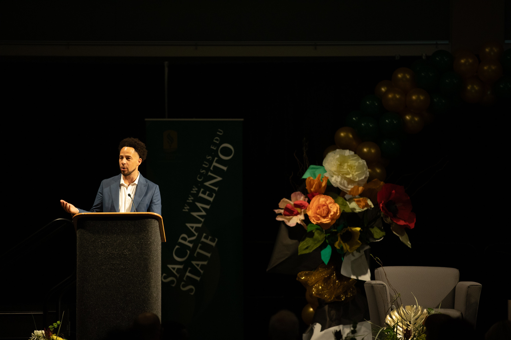 Photograph of President Luke Wood at a podium.