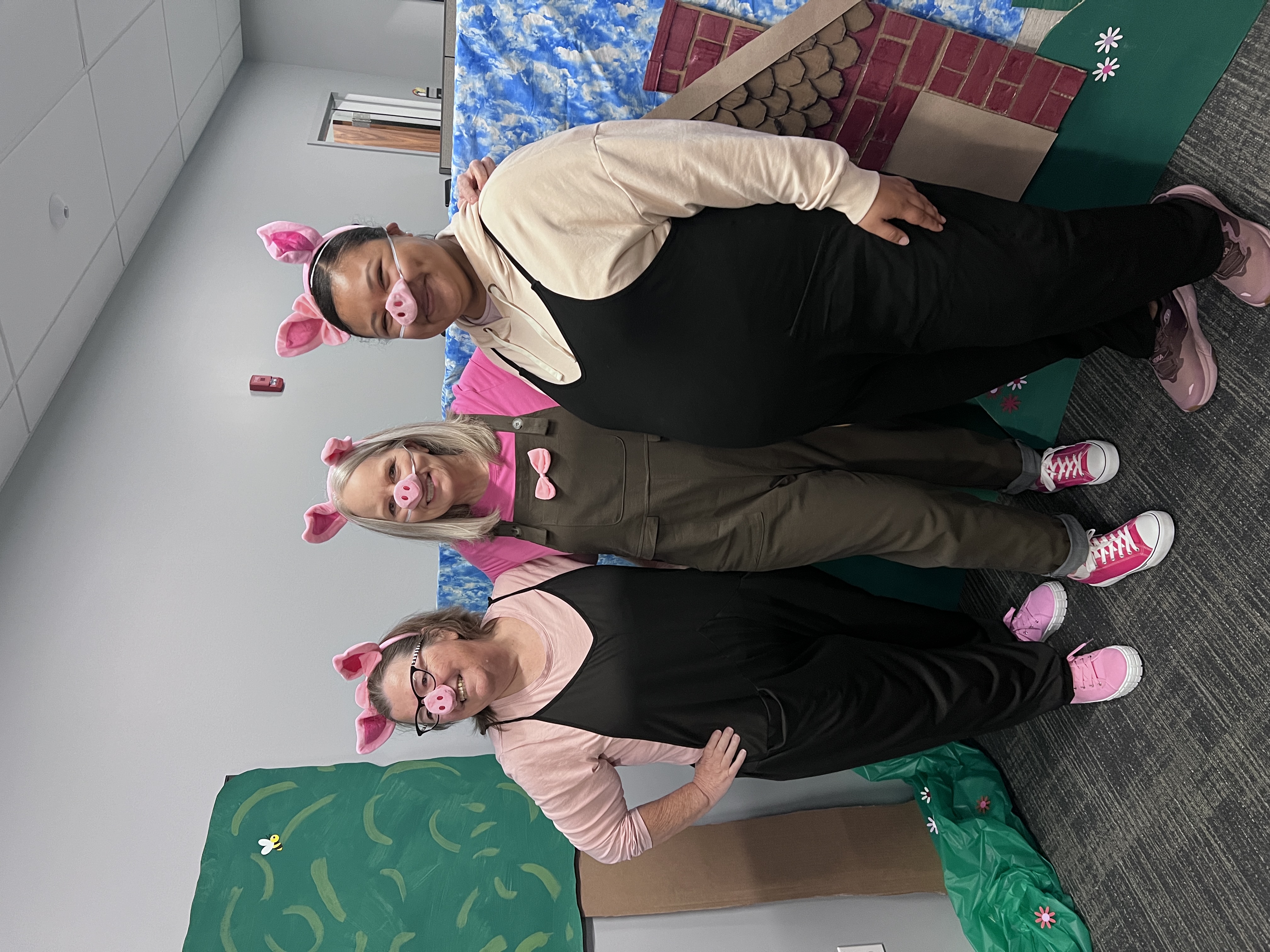 Dressed like the Three Little Pigs for Halloween in decorated office