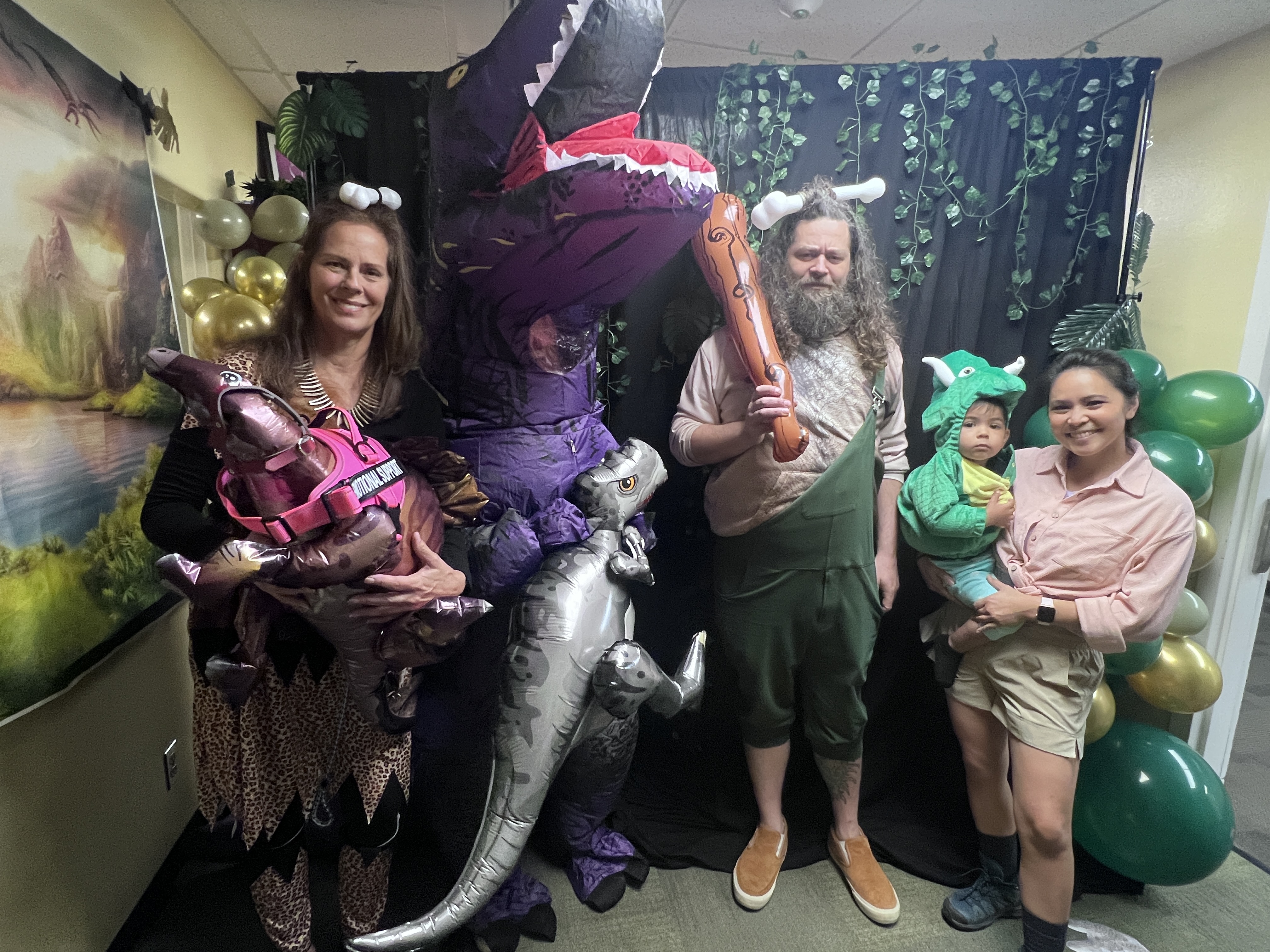 Group dressed up as dinosaurs and cave people for Halloween